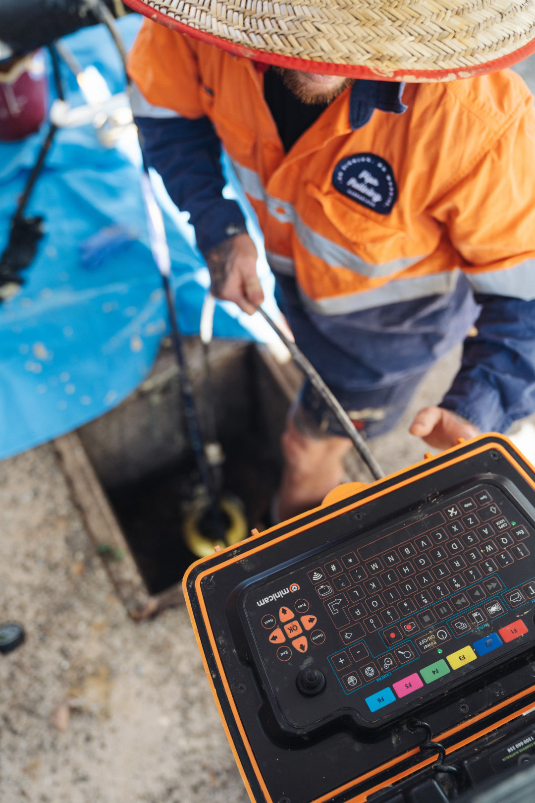 An image of a man working on a computer in a trench